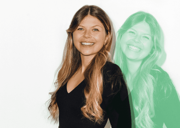 Smiling young woman with long hair wearing a black top, posed against a white background with a green shadow effect.